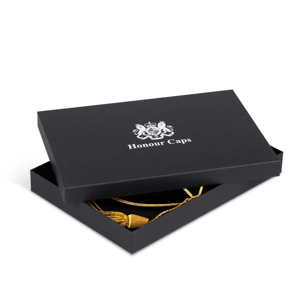 graduation cap mounted in a black cardboard box 